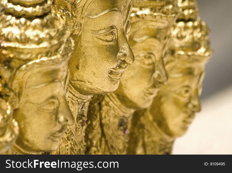 Statue of four golden buddha in a warm atmosphere