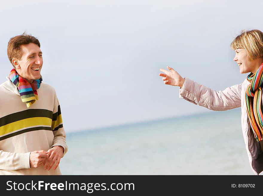 Young couple isolated over sky and sea background