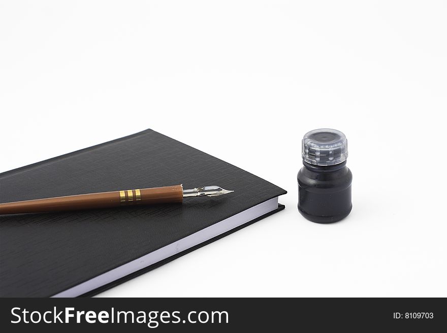 Notebook with pen and ink isolated on white