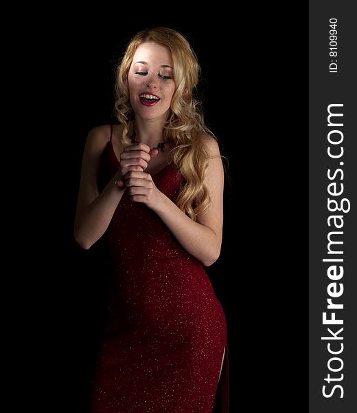 Beautiful blonde young lady in red dress singing. Beautiful blonde young lady in red dress singing