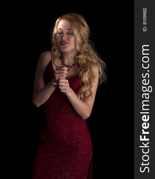 Beautiful blonde young lady in red dress singing. Beautiful blonde young lady in red dress singing