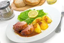 Roasted Slices Of Pork With Lettuce And Fried Pota Royalty Free Stock Image
