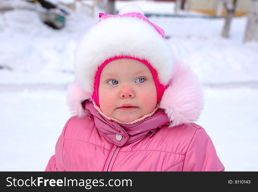 Pretty little girl in winter outerwear - outdoor portrait. Pretty little girl in winter outerwear - outdoor portrait.