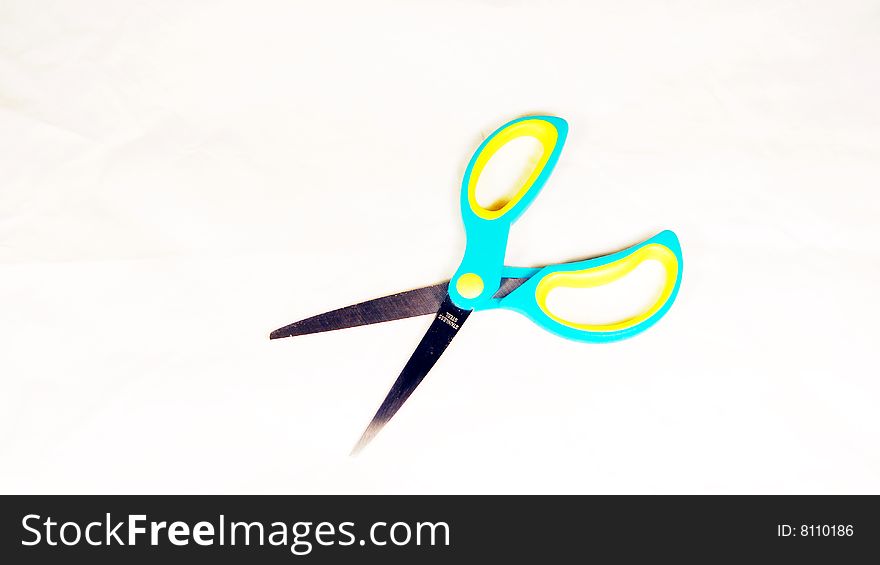 Colourful scissors on white background.