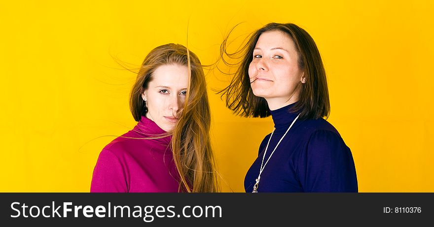 Close-up portrait of beautiful girl. Isolated over yellow background