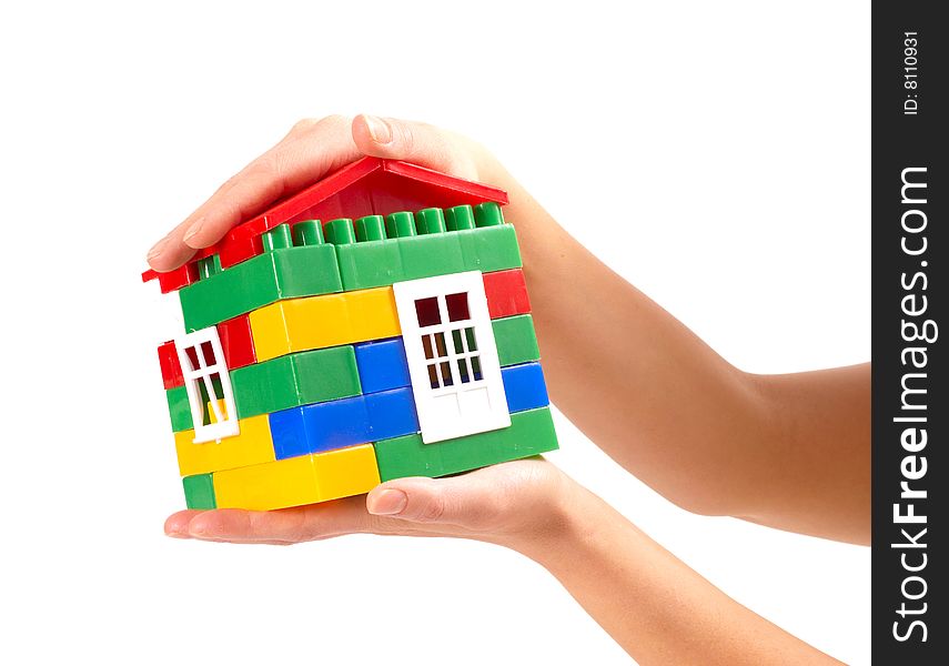 Small house in woman hands isolated on white