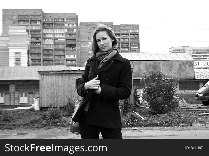 A girl standing in front of houses. A girl standing in front of houses