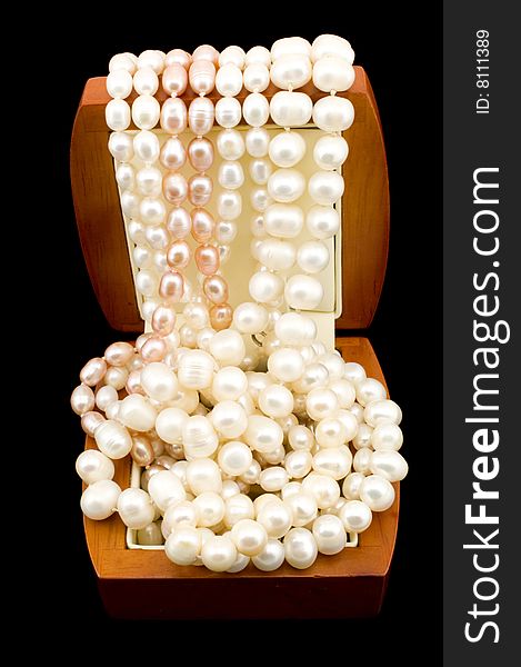 Handful of pearls in box isolated on a black background