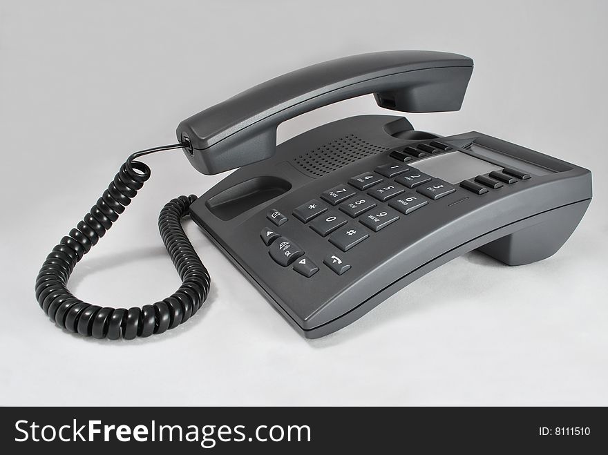 Grey office phone with lifted tube