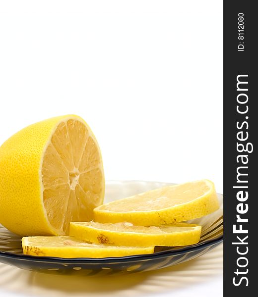 Lemon slices on plate isolated on white