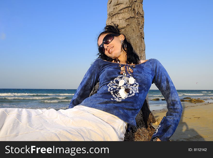 Trendy young fashion woman relaxing on tropical beach. Trendy young fashion woman relaxing on tropical beach