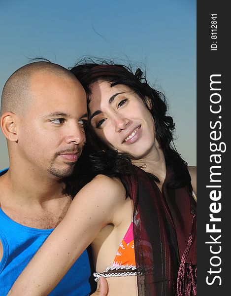 Portrait of young hispanic happy couple relaxing at sunset. Portrait of young hispanic happy couple relaxing at sunset