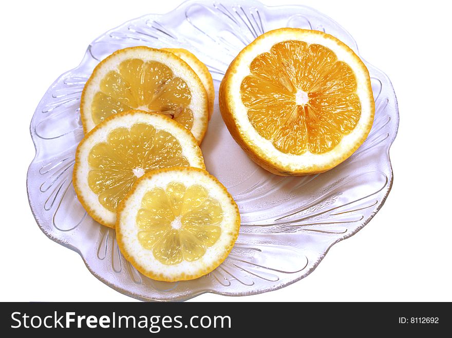 Ripe yellow lemon on a white background in a dish. Ripe yellow lemon on a white background in a dish