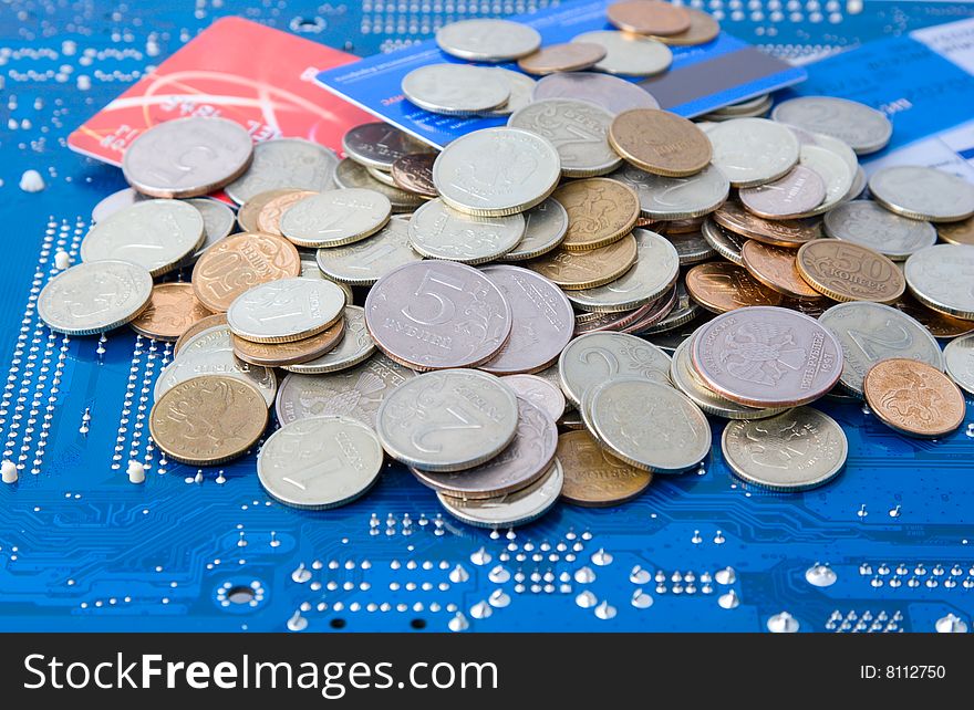 Technology business: money and credit cards on circuit board background