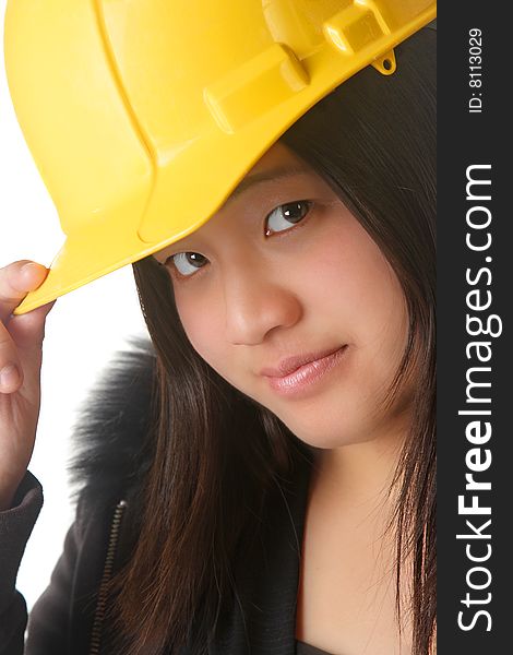 An attractive lady wearing a yellow hardhat. An attractive lady wearing a yellow hardhat.