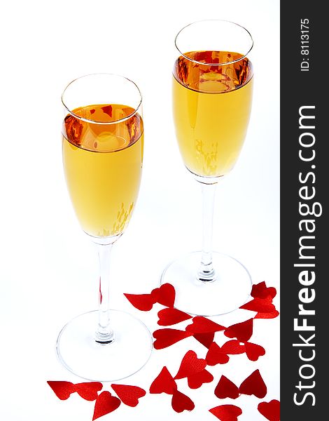 Two wine glasses and red small hearts. Two wine glasses and red small hearts