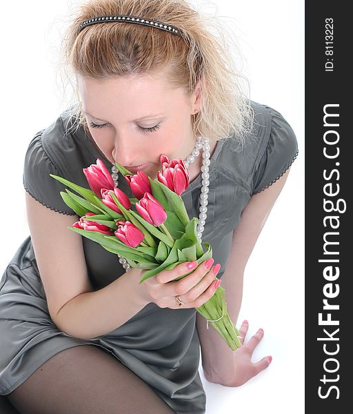 Beautiful young woman with pink tulips