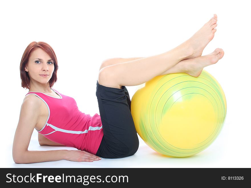 Young woman exercising with a pilates ball. Young woman exercising with a pilates ball
