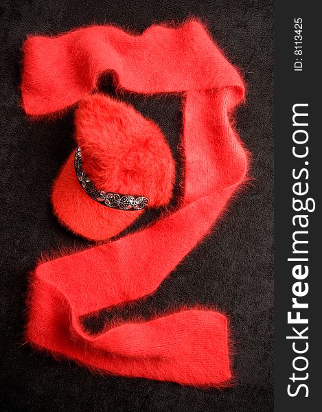 Red cap and scarf on a black drapery. Red cap and scarf on a black drapery.