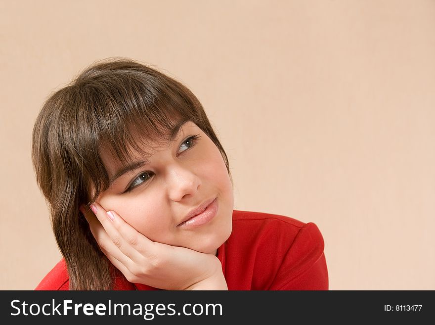 Young dreamy girl with hand on the chin