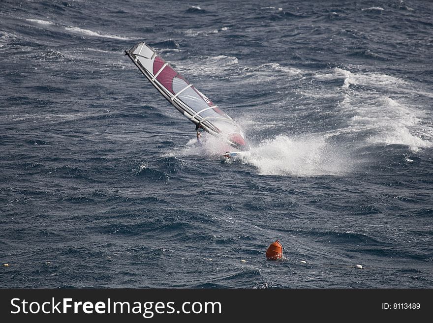 Wind surfer on blue sea. Wind surfer on blue sea