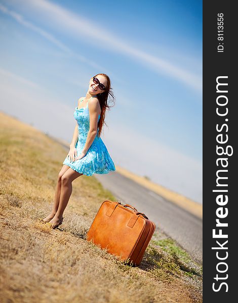 Laughing girl near the suitcase. Laughing girl near the suitcase