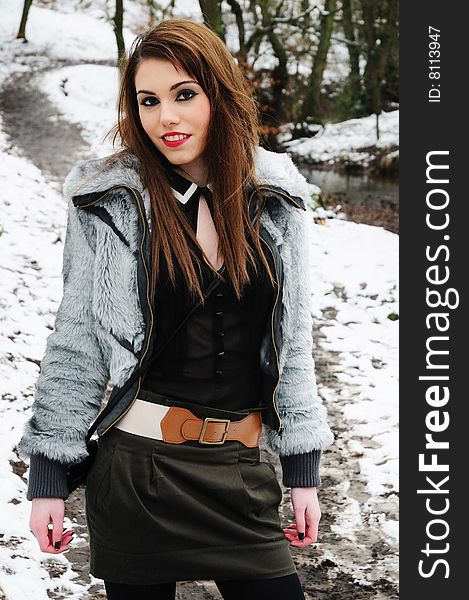 Female model standing in the woods on a cold snowy day. Female model standing in the woods on a cold snowy day