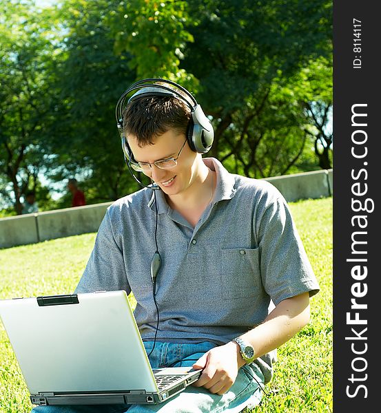 Guy Listens Music On A Laptop