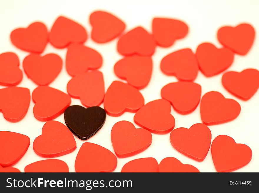 Black heart with a lot of small wooden hearts put on white background. Black heart with a lot of small wooden hearts put on white background