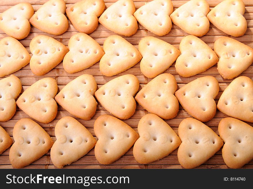 Rows of heart shaped cheese biscuits. Rows of heart shaped cheese biscuits