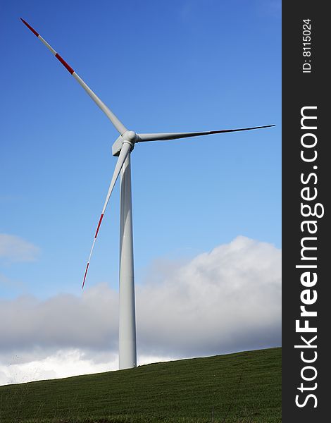 Modern and ecologic wind turbine and blue sky