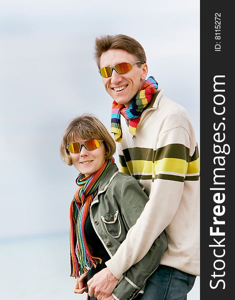 Young couple portrait, isolated over sky