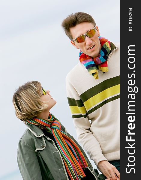 Young couple portrait, isolated over sky