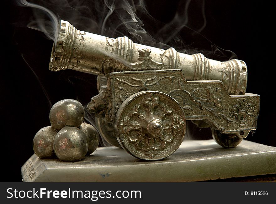 Shot from an ancient gun on a black background. Shot from an ancient gun on a black background