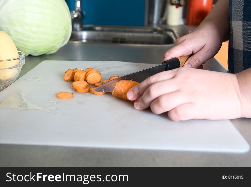 Soup  preparation: woman slice carrot