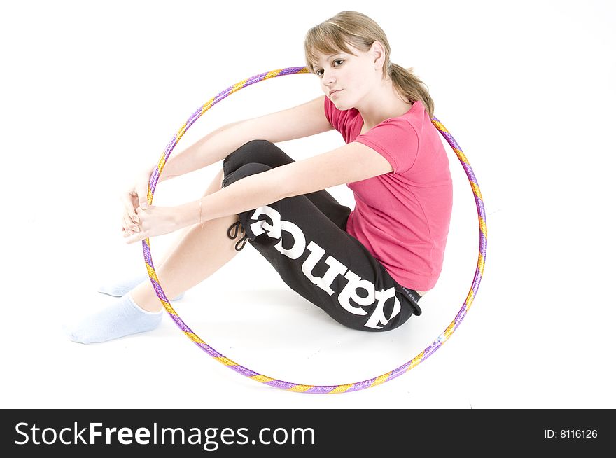 A young girl dealing with a sports hoop. A young girl dealing with a sports hoop