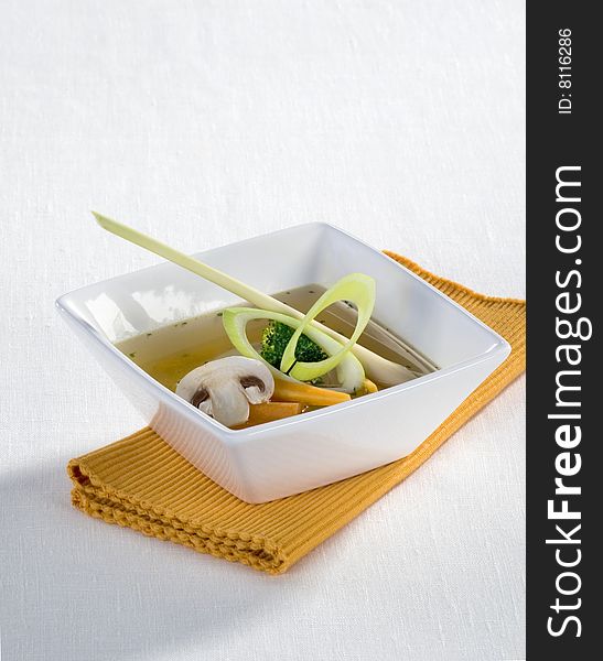 Soup with vegetables in a square bowl