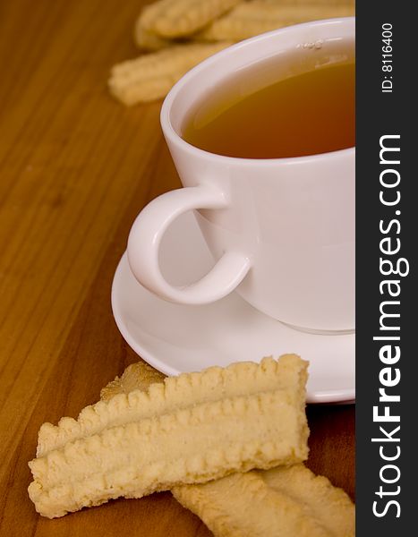 Cup of tea and some cookies on wooden table