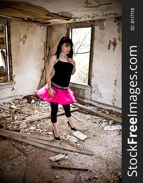 Pretty young woman wearing a pink tutu in an abandoned building. Pretty young woman wearing a pink tutu in an abandoned building