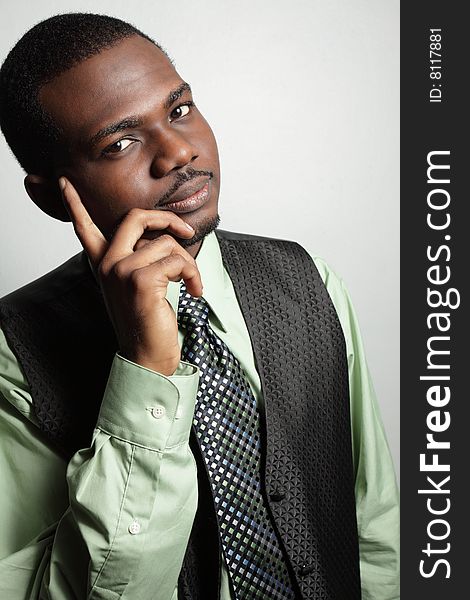 Young businessman posing with his hand on his face. Young businessman posing with his hand on his face