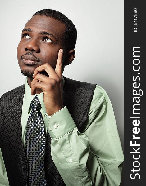 Young businessman posing with his hand on his face. Young businessman posing with his hand on his face