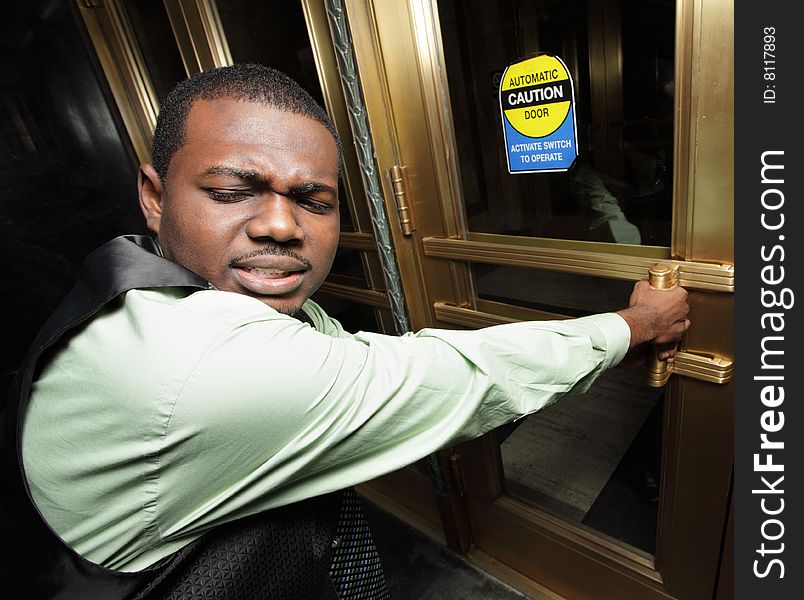 Businessman trying to open an electronic door. Businessman trying to open an electronic door