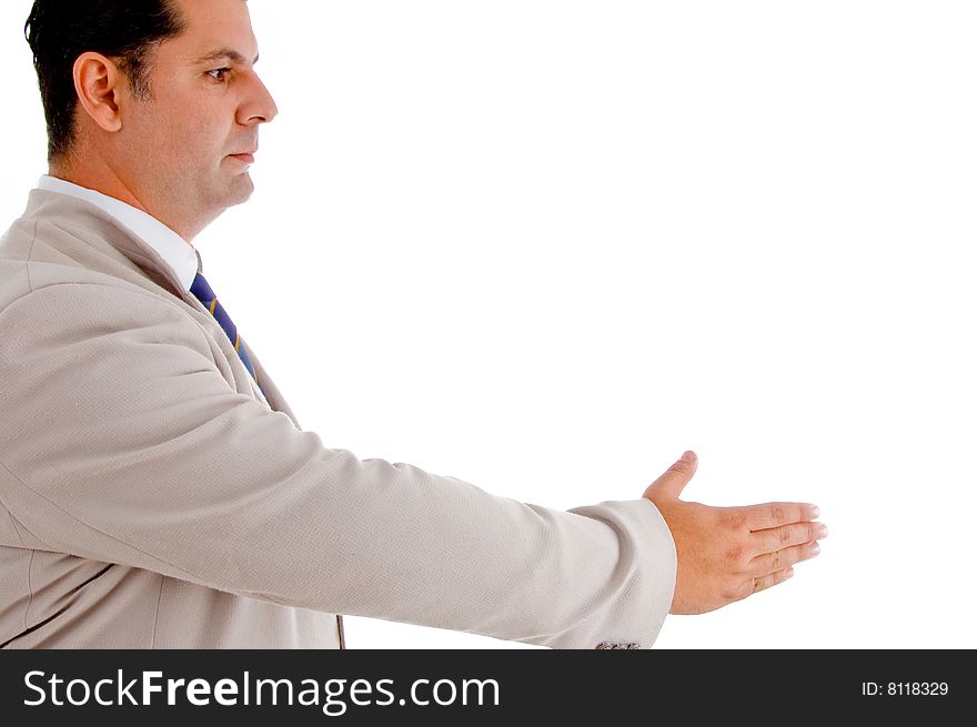 Winning businessman in suit offering handshake against white background. Winning businessman in suit offering handshake against white background