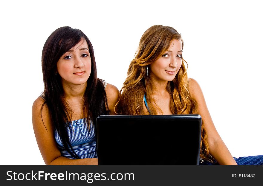 Portrait of young female students with laptop against a white background