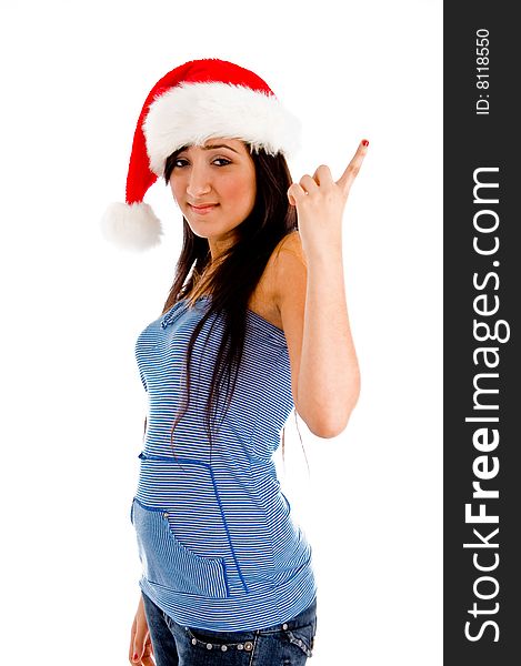 Side view of pointing girl with christmas hat against an isolated background