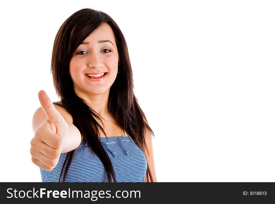 Smiling young girl showing you thumb up against white background. Smiling young girl showing you thumb up against white background