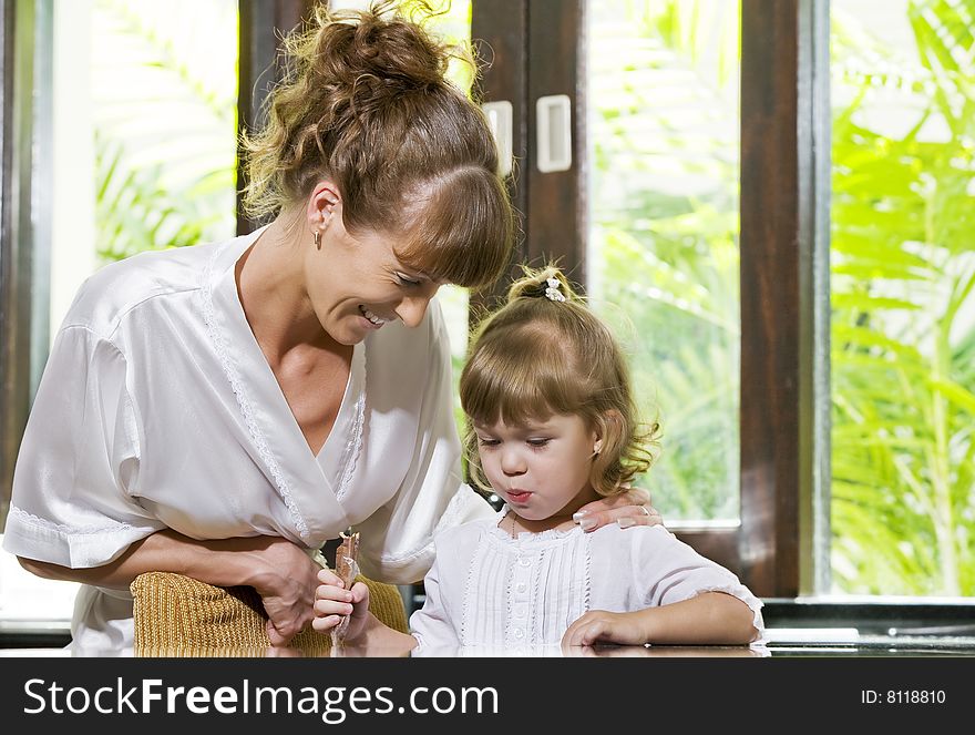 Portrait of young woman having good time her baby daughter. Portrait of young woman having good time her baby daughter