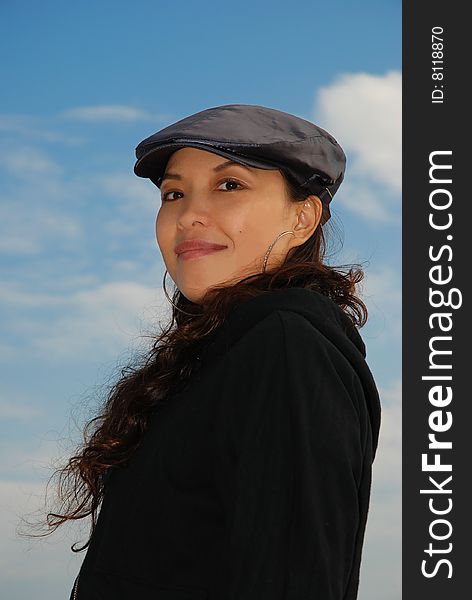 Young Asian Woman with charming smile over blue sky. Young Asian Woman with charming smile over blue sky