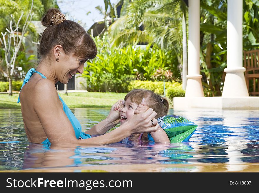 Portrait of young attractive woman having good time with her daughter. Portrait of young attractive woman having good time with her daughter