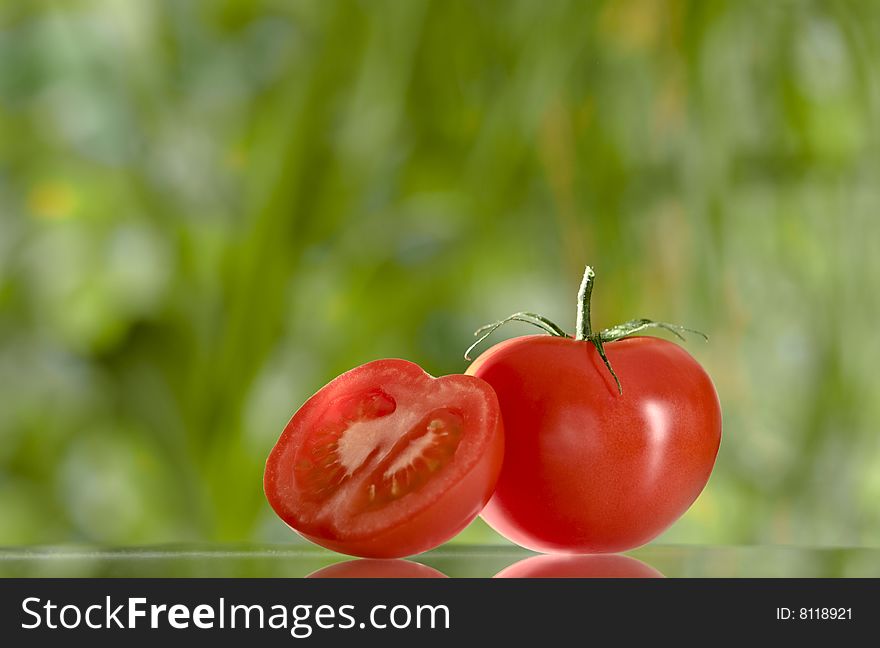 Close up view of nice red fresh tomato on green  back. Close up view of nice red fresh tomato on green  back